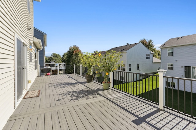 wooden deck with a lawn