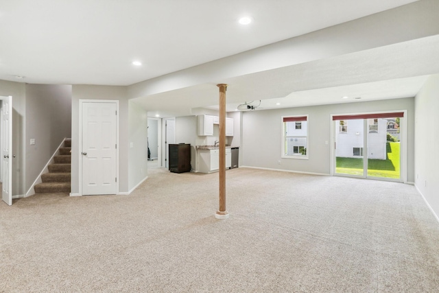 basement featuring light colored carpet