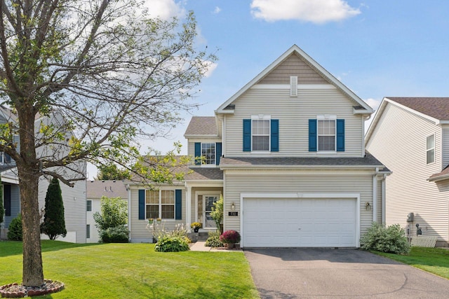 front of property with a garage and a front lawn