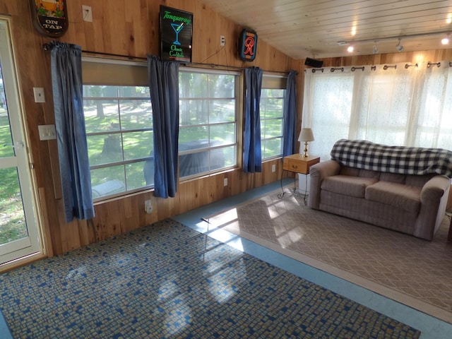 unfurnished sunroom featuring wood ceiling, a wealth of natural light, and lofted ceiling