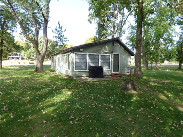 49215 Middle Leaf Rd, Henning, MN 56551 - rear view of house with a patio area, a lawn, and entry steps