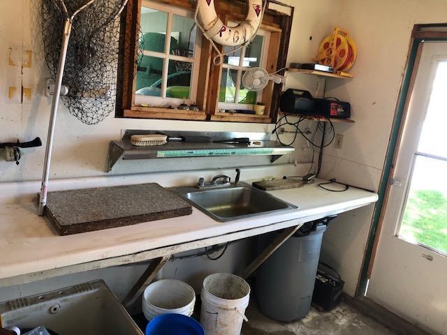 49215 Middle Leaf Rd, Henning, MN 56551 - interior space with light countertops, concrete floors, and a sink