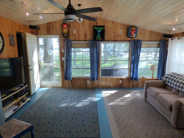 living room with wood ceiling, wooden walls, vaulted ceiling, and ceiling fan