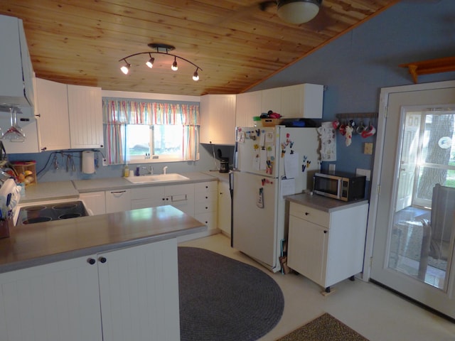 49215 Middle Leaf Rd, Henning, MN 56551 - kitchen featuring freestanding refrigerator, wooden ceiling, a sink, stainless steel microwave, and white cabinetry