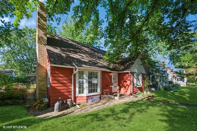 rear view of property featuring a yard