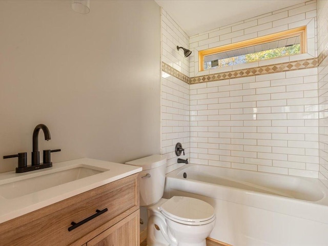 full bathroom featuring tiled shower / bath combo, vanity, and toilet