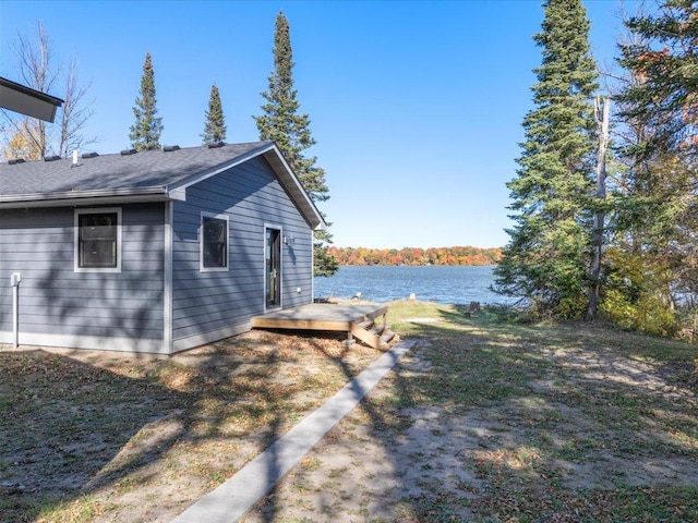 exterior space featuring a deck with water view