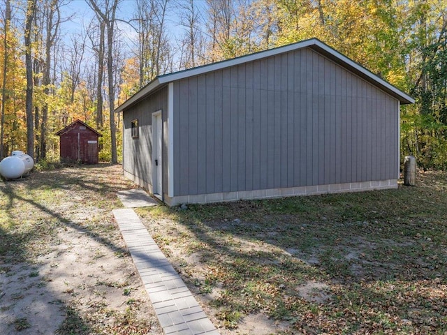 view of home's exterior with an outbuilding