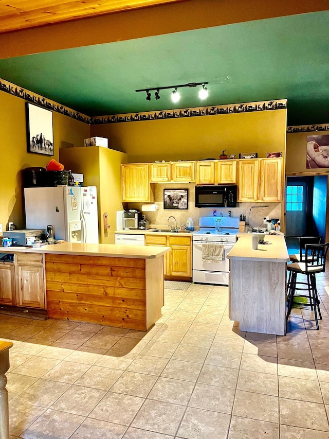 30925 County Road 5 NW, Spencer Brook Twp, MN 55371 - kitchen featuring light tile patterned floors, white appliances, light countertops, and a sink