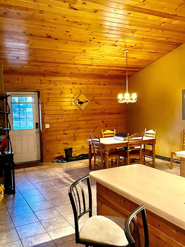 dining room featuring a notable chandelier, wood ceiling, light tile patterned floors, and lofted ceiling