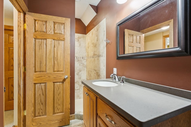 bathroom with lofted ceiling and vanity