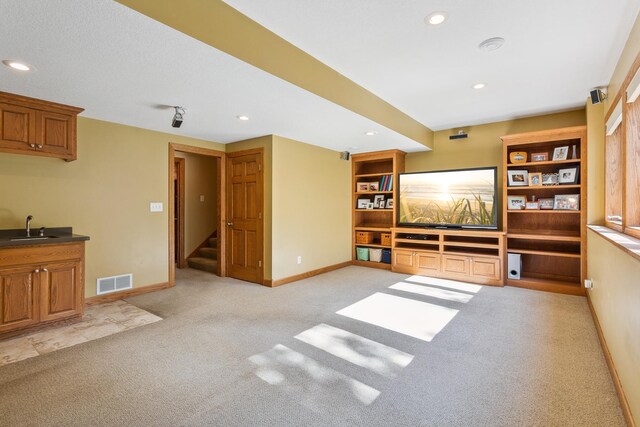 carpeted living room featuring sink