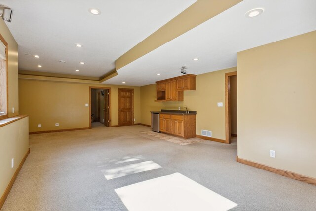 unfurnished living room with light colored carpet