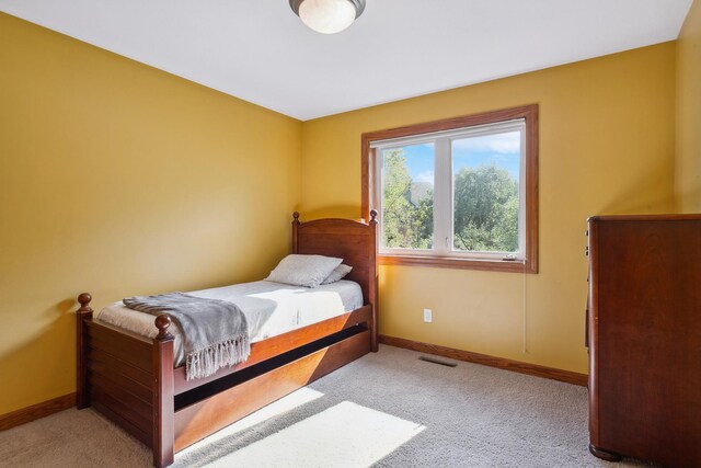 bedroom featuring light carpet