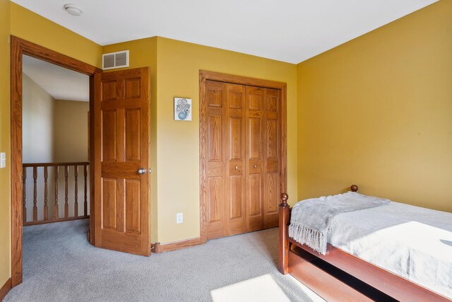 bedroom with light carpet and a closet