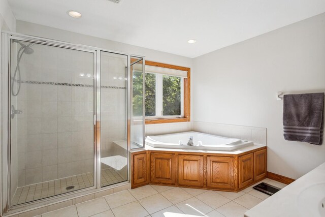 bathroom featuring tile patterned flooring and separate shower and tub