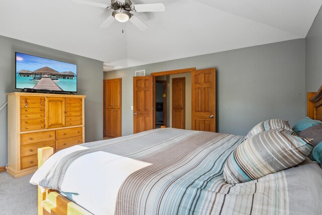 bedroom with ceiling fan, carpet floors, and lofted ceiling