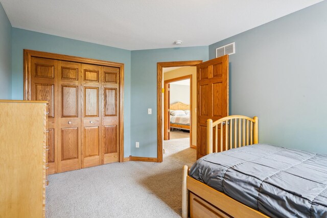 carpeted bedroom with a closet