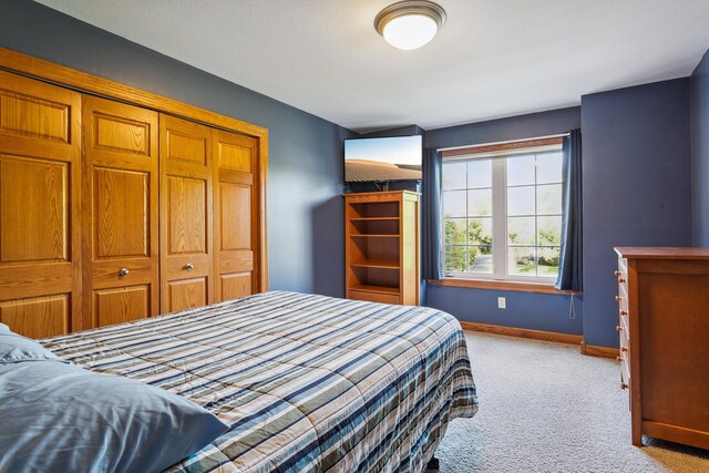 carpeted bedroom with a closet