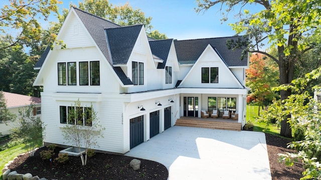 rear view of property featuring a garage