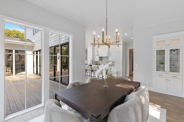 dining room featuring a notable chandelier and light hardwood / wood-style flooring