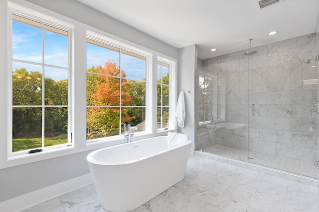 bathroom with shower with separate bathtub