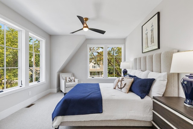 bedroom with ceiling fan, carpet flooring, and multiple windows