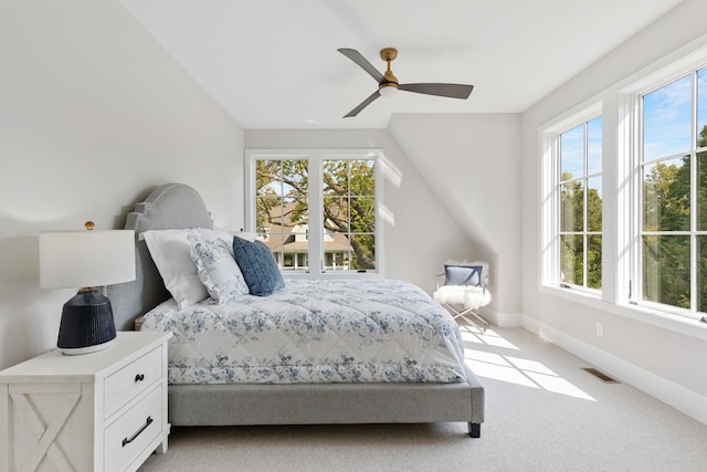 carpeted bedroom with multiple windows and ceiling fan