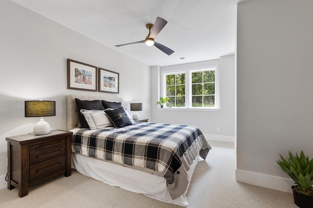 bedroom with ceiling fan and light colored carpet