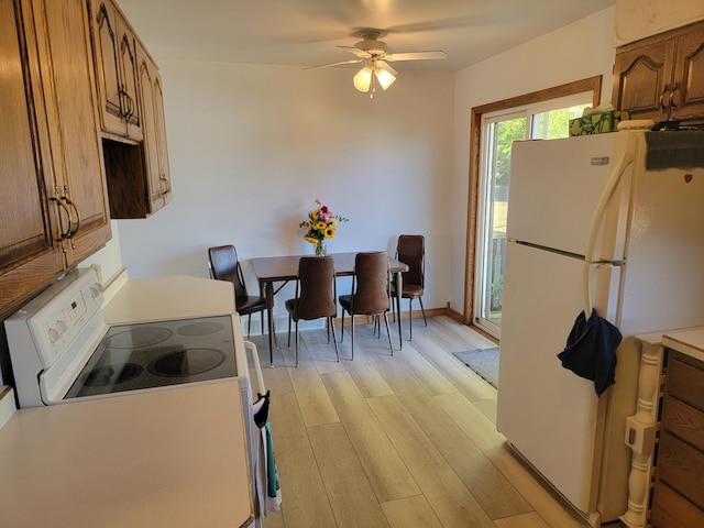 kitchen featuring light wood-type flooring, white appliances, and ceiling fan