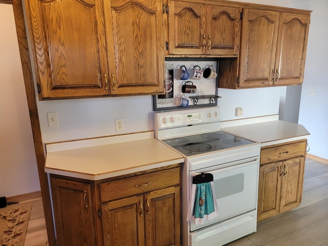 kitchen with light hardwood / wood-style floors and white electric range