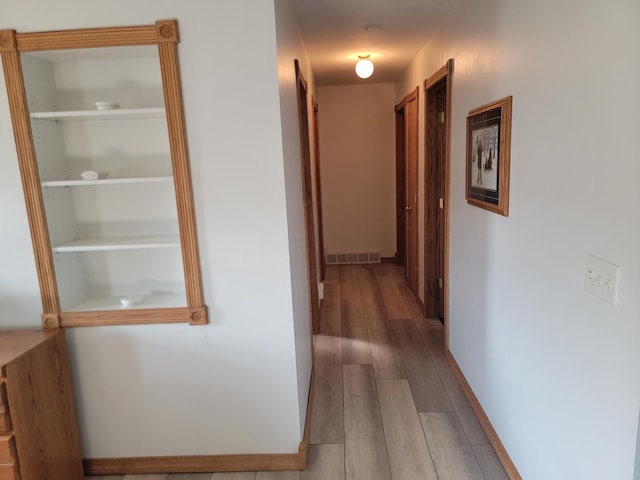 hallway featuring hardwood / wood-style flooring