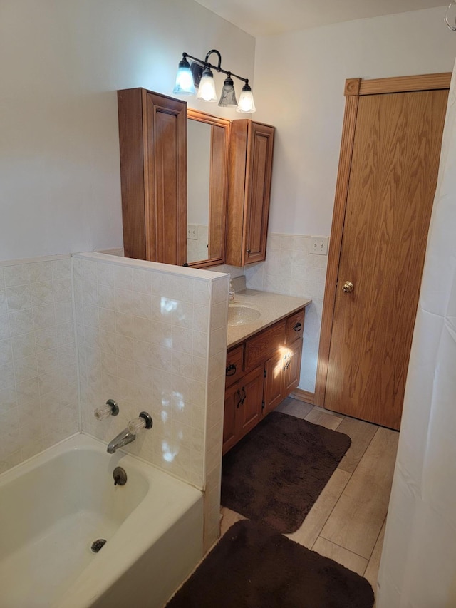 bathroom featuring vanity and a washtub