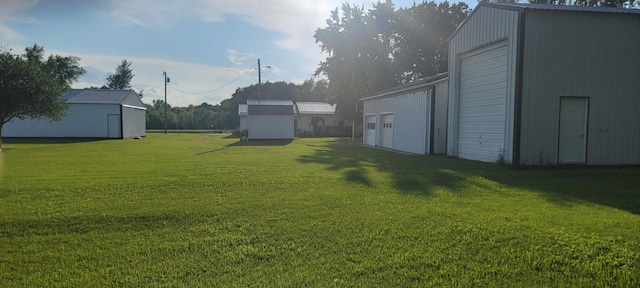 view of yard with an outbuilding and a garage