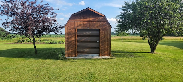 view of outbuilding with a yard