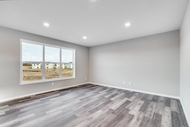 unfurnished room with light hardwood / wood-style flooring