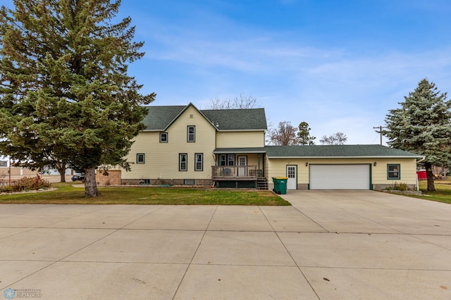 view of front of property featuring a garage and a front lawn