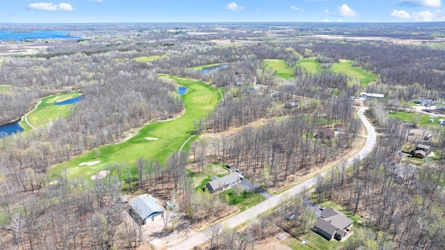 birds eye view of property featuring a wooded view, view of golf course, and a water view