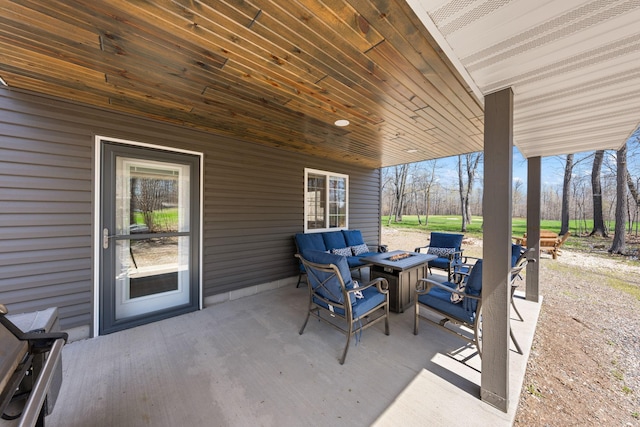 view of patio featuring an outdoor living space with a fire pit