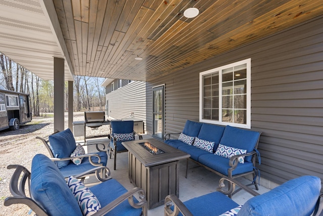 view of patio featuring an outdoor living space with a fire pit