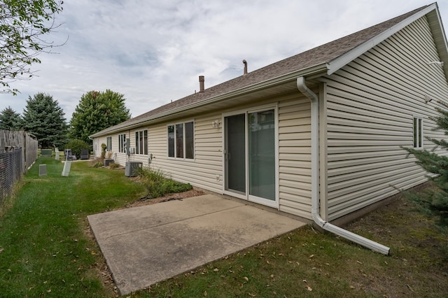 back of house with a lawn, central AC, and a patio area