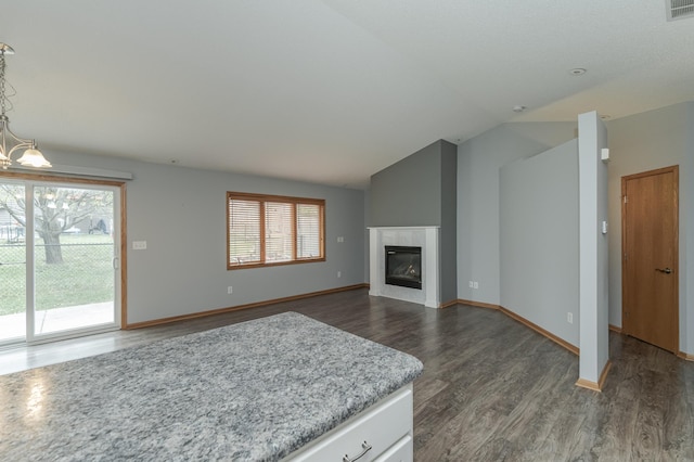 unfurnished living room with lofted ceiling and dark hardwood / wood-style floors