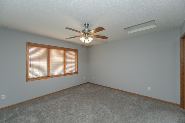 carpeted spare room with ceiling fan and a textured ceiling