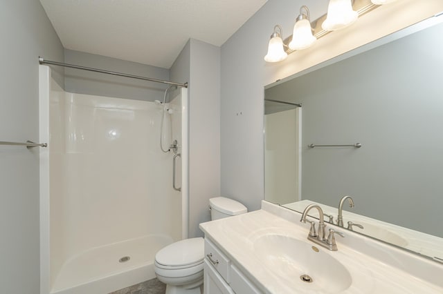 bathroom with a textured ceiling, a shower, vanity, and toilet