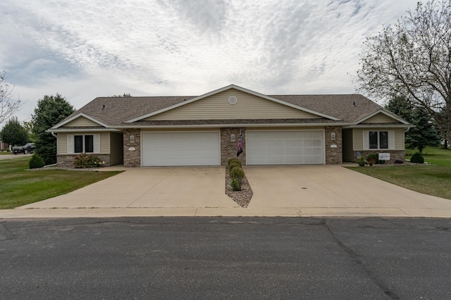 ranch-style house featuring a front lawn and a garage