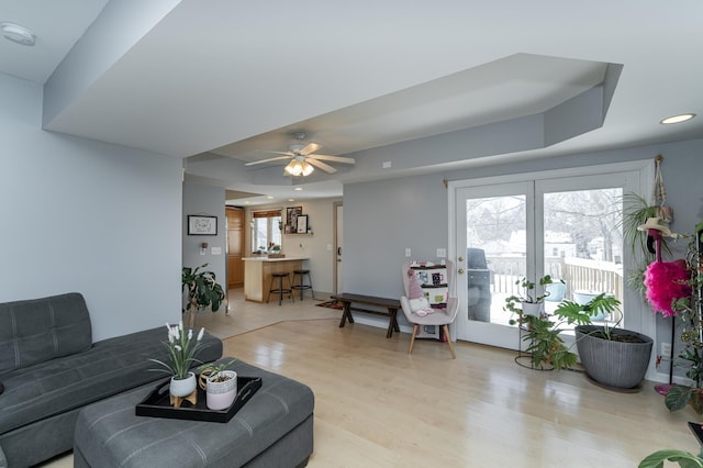 living room featuring recessed lighting, light wood-style flooring, and a ceiling fan