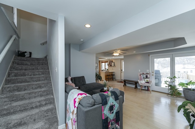 living area featuring stairway, recessed lighting, a healthy amount of sunlight, and light wood finished floors