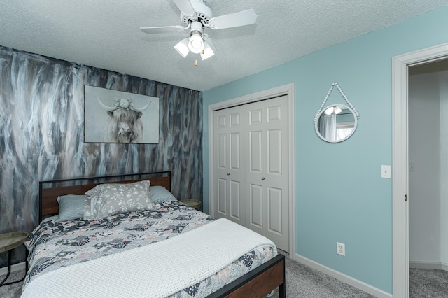 bedroom featuring baseboards, ceiling fan, carpet, a closet, and a textured ceiling