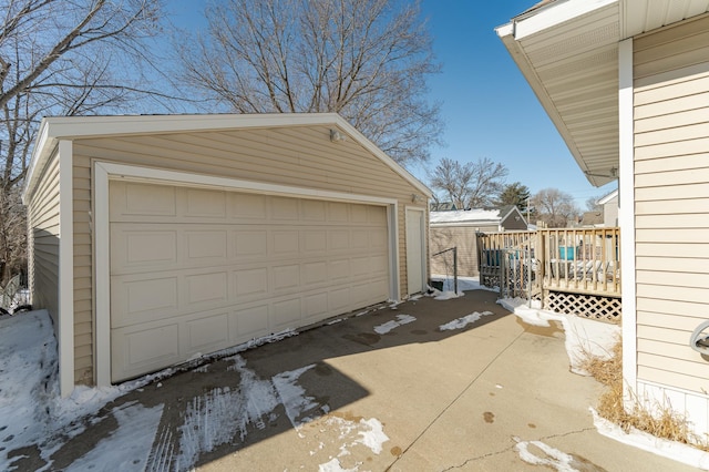 snow covered garage featuring a garage