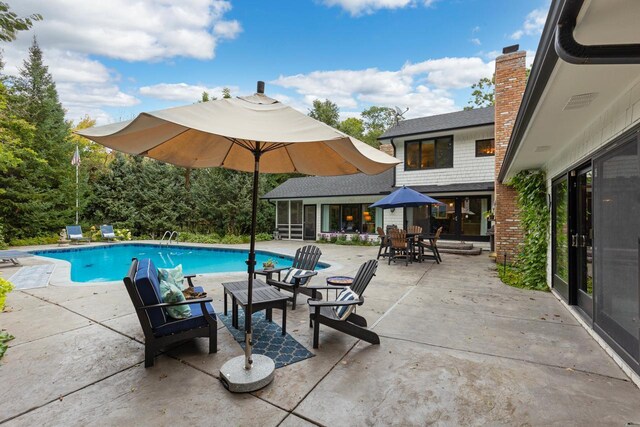 view of swimming pool with a patio